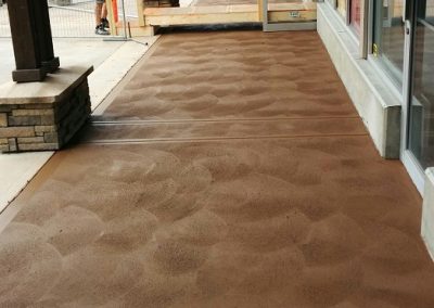 Brown concrete sidewalk beside a commercial building