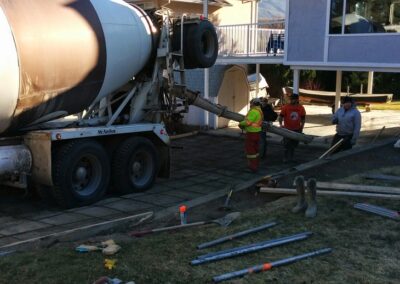 Concrete mixer truck pouring concrete for a new driveway