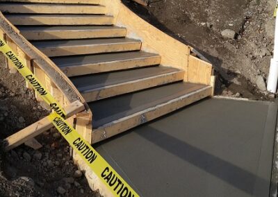 Large concrete staircase with forms in place and drying concrete