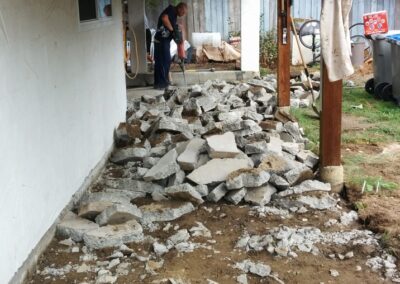 Pile of broken concrete being removed with a jackhammer